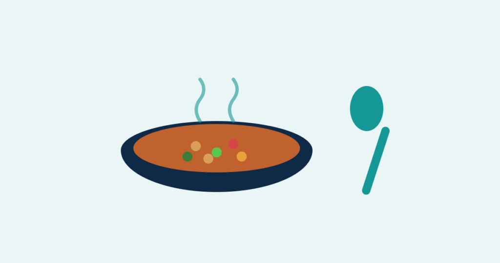 A steaming bowl of lentil and vegetable soup with a spoon